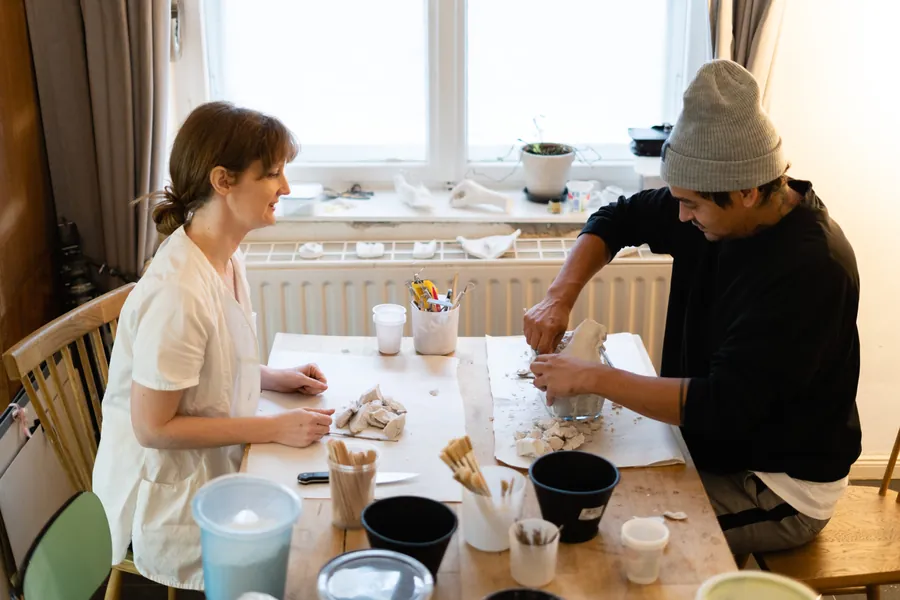 Two people at a studio table during a casting workshop